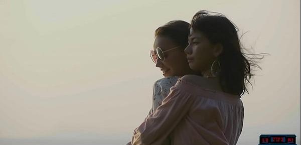  Lesbian Asian and European girlfriends playing in the ocean